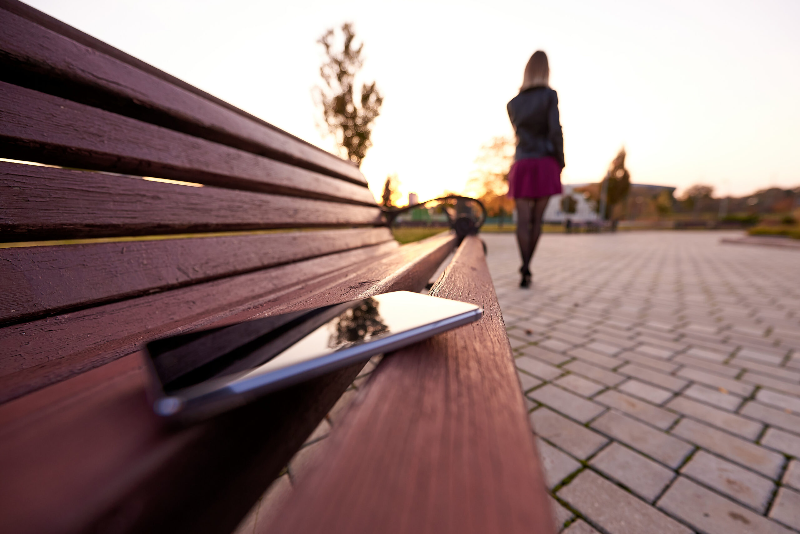 Forgotten smartphone on a park bench. Phone on bench